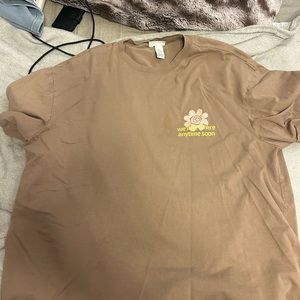 Tan shirt. Designs on front and back.